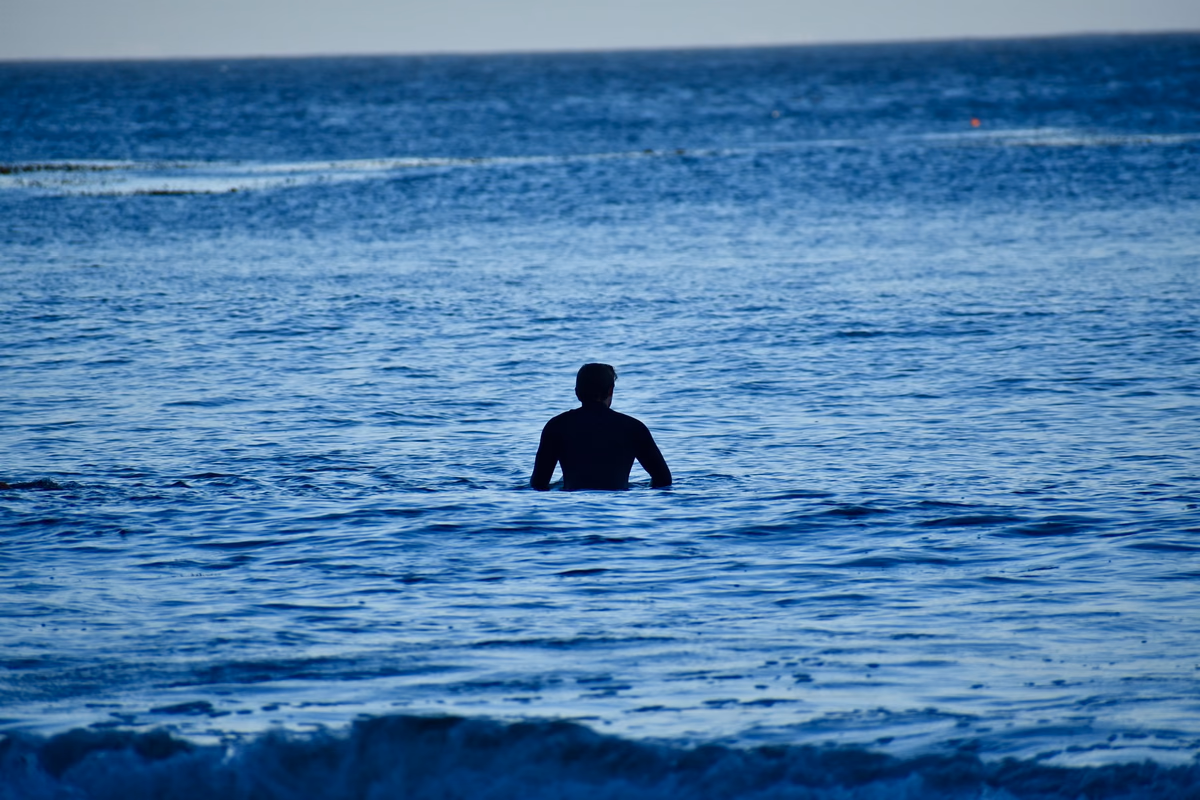 Sitting out past the break, waiting on a wave